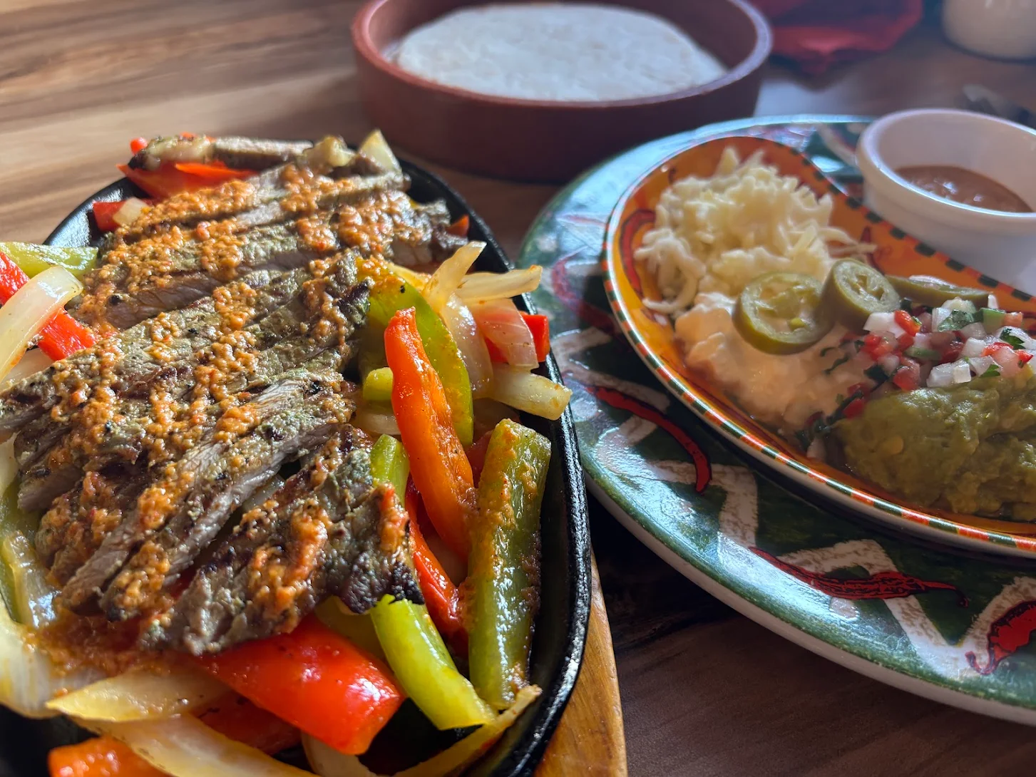 Sizzling steak fajitas with peppers, onions, rice, guacamole and salsa at Fiesta Mexicana in Orpington